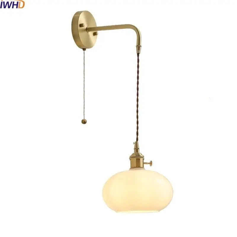 Modern glass copper led wall lights featuring brass-finished sconce with twisted cord and opalescent glass globe