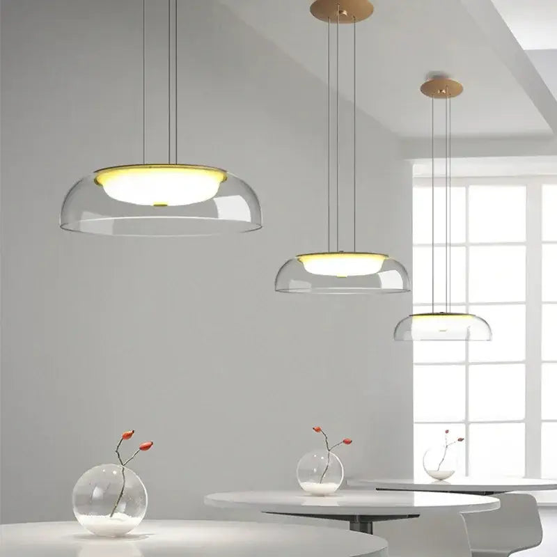 Modern glass dome pendant lights with warm yellow illumination and wooden ceiling fixture for dining room use