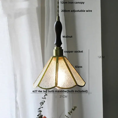 A warm-toned glass flower led pendant light with textured glass and walnut iron canopy for dining room lighting