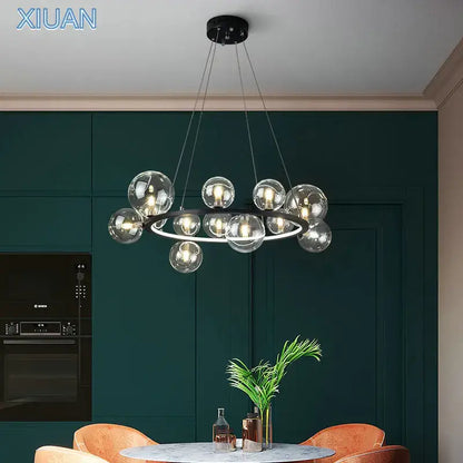 Modern glass chandelier lamp with sleek black circular frame and hanging transparent spheres for kitchen island lighting