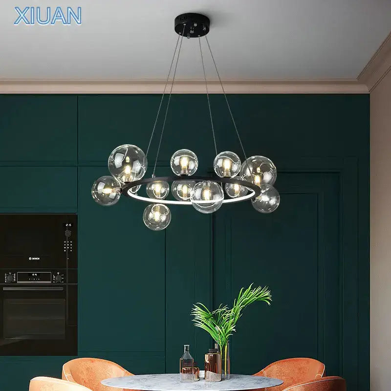 Modern glass chandelier lamp with sleek black circular frame and hanging transparent spheres for kitchen island lighting