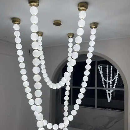 A modern glass gold pendant light with frosted white bulb strands and brass-finished fixtures for living room decorbites glass gold