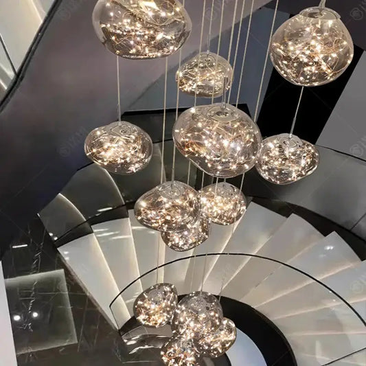 A modern glass orb pendant light with warm glowing led bulbs for elegant living room led illumination