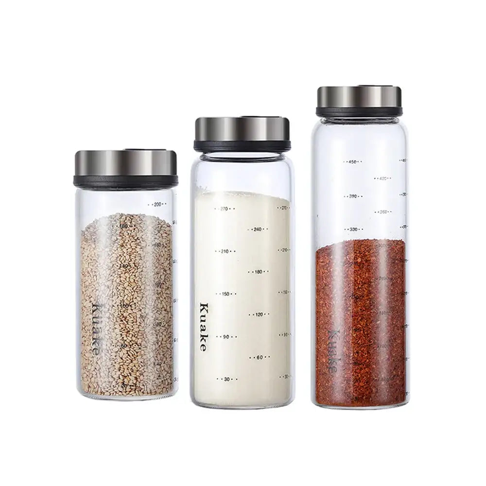 Three clear glass seasoning jars with silver lids labeled kuake for use as shaker salt pepper kitchen storage