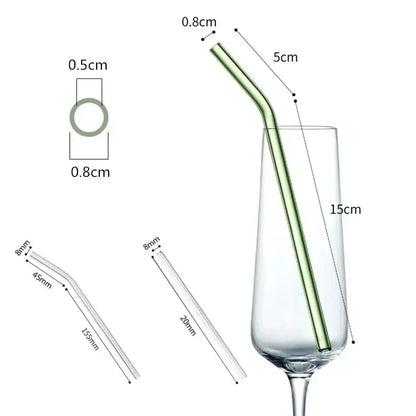 Slender translucent green glass straw with curved design in champagne flute from decorbites glass straw set
