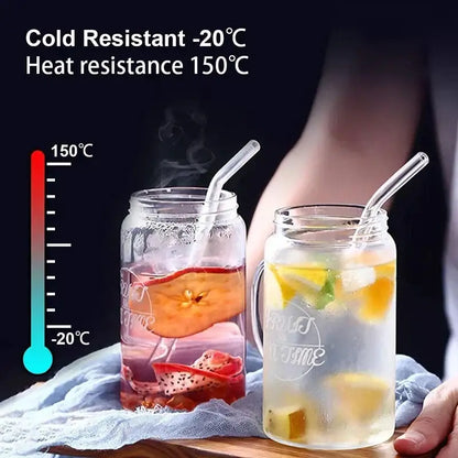 Clear glass mason jar with handle and fruit of the time design filled with fruit-infused drinks and decorbites glass straw set