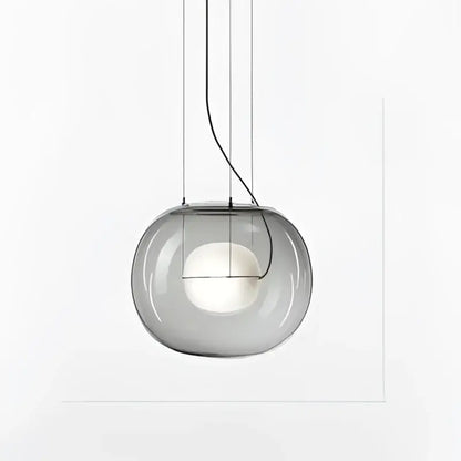 Modern glossy black glass ball pendant light featuring a sleek translucent gray glass pendant light with visible bulb decorbites brokis big