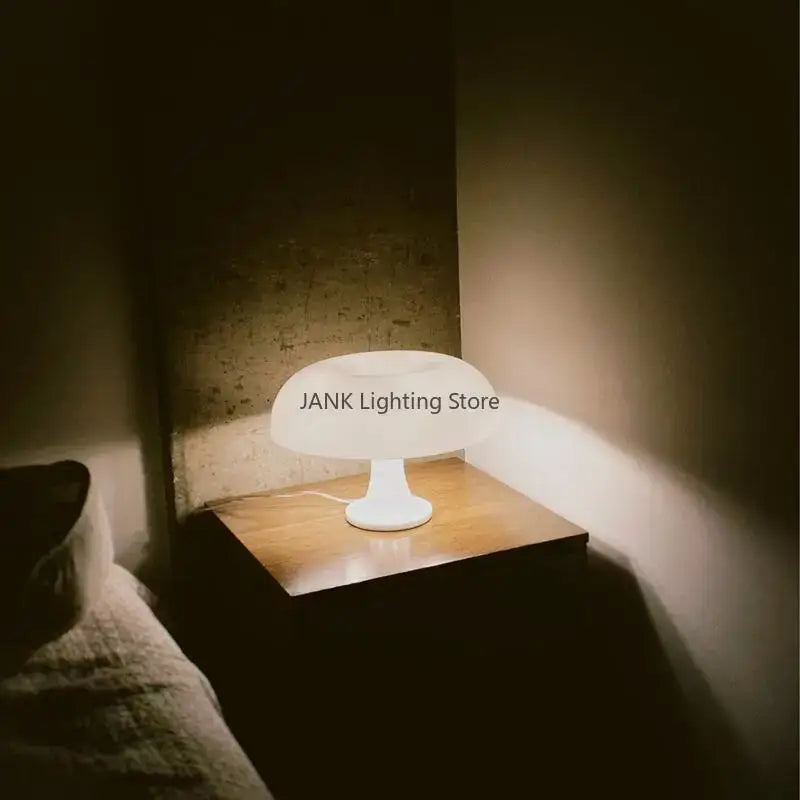 A sleek minimalist white mushroom table lamp with a glossy finish perfect for modern led bedroom lighting