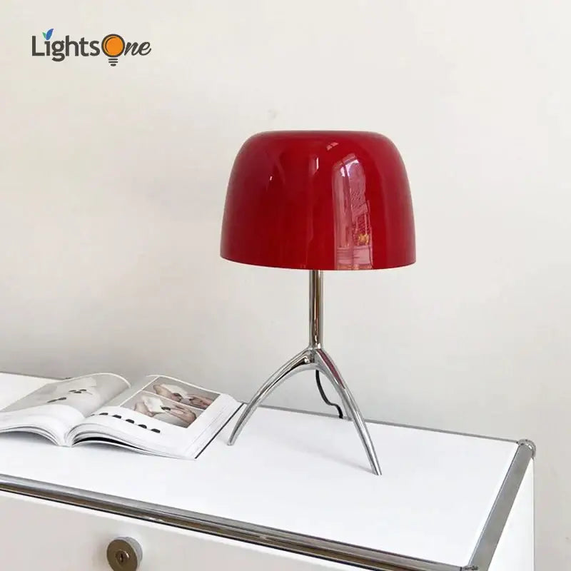 A sleek glossy red candy color table light with modern tripod base ideal for bedroom decorbites candy color decor