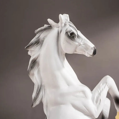 A sleek white glossy resin horse statue with gray shading in a poised rearing stance for modern living room decorbites horse statue