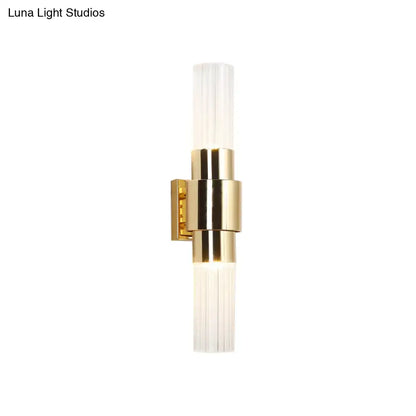 Modern gold 2 light sconce with clear ribbed glass shades and bulb base for bathroom wall lighting
