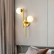 Modern gold 2-light wall lamp with spherical frosted glass shades for living room glass sconce lighting type