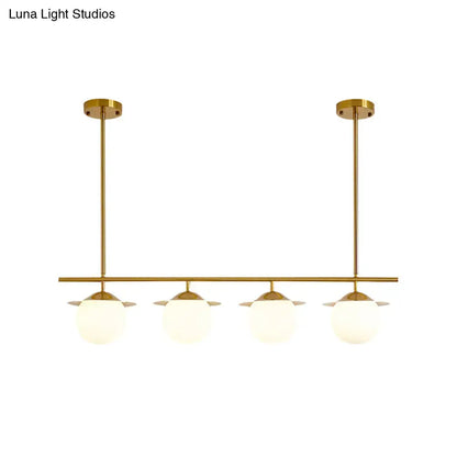 DecorBites gold pendant light with four frosted opal glass globes for contemporary round island lighting