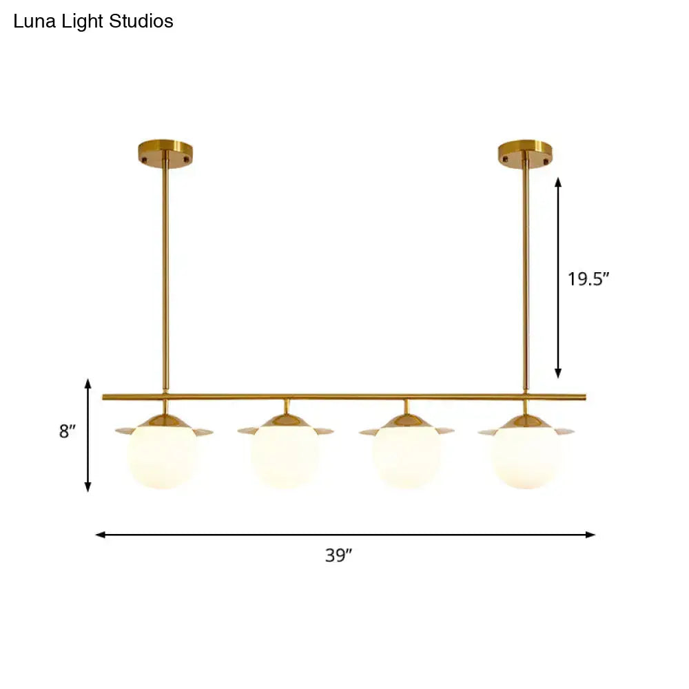 DecorBites gold opal glass round island pendant light with four frosted glass globes in a modern gold-toned finish