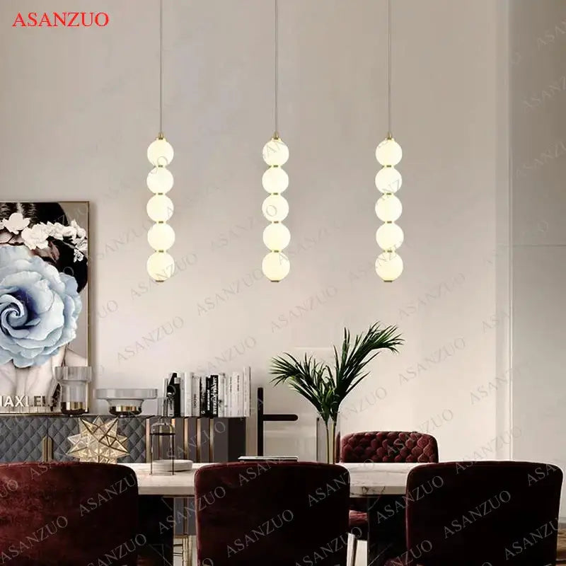 Three modern gold glass ball pendant lights with cascading frosted spheres for dining room decorbites pendant lights