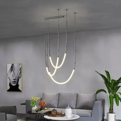 Modern gold acrylic bamboo pendant light with brushed nickel finish featuring sleek metallic rods and curved led strips