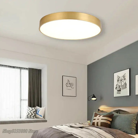 Modern gold acrylic led ceiling light with a round gold metallic frame and white illuminated center for living room