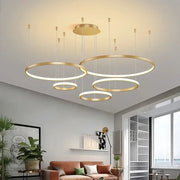 Modern gold acrylic led ring pendant light with illuminated circular rings for dining room decorbites acrylic led decor