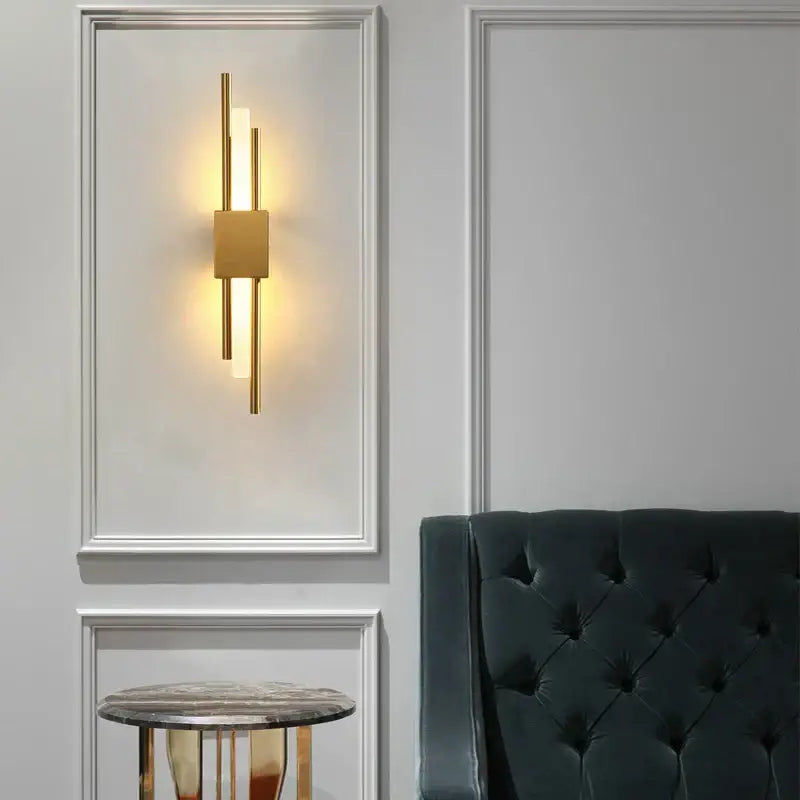 Modern gold acrylic pipe led wall lamp with vertical cylindrical rods and central panel emitting warm light wall sconce