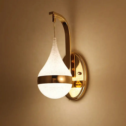 Modern gold acrylic waterdrop wall light fixture with frosted glass teardrop shade and polished brass band for bedroom sconce