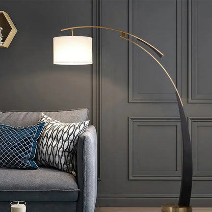 A sleek curved gold-toned decorbites adjustable metal floor lamp with a white cylindrical shade for living room decor