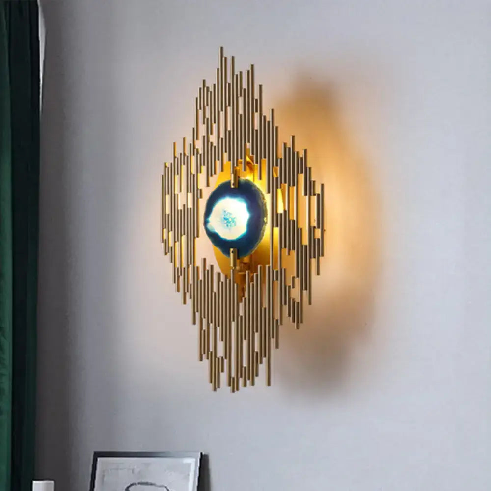Modern gold agate deco living room wall sconce with radiating vertical bars and central glowing blue orb inch fixture