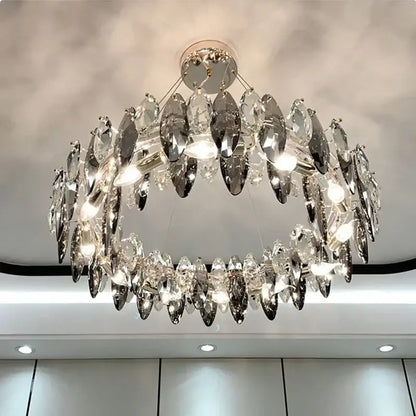 A modern gold amber decorbites crystal ceiling chandelier with two-tiered clear and silver-toned glass pieces for dining room