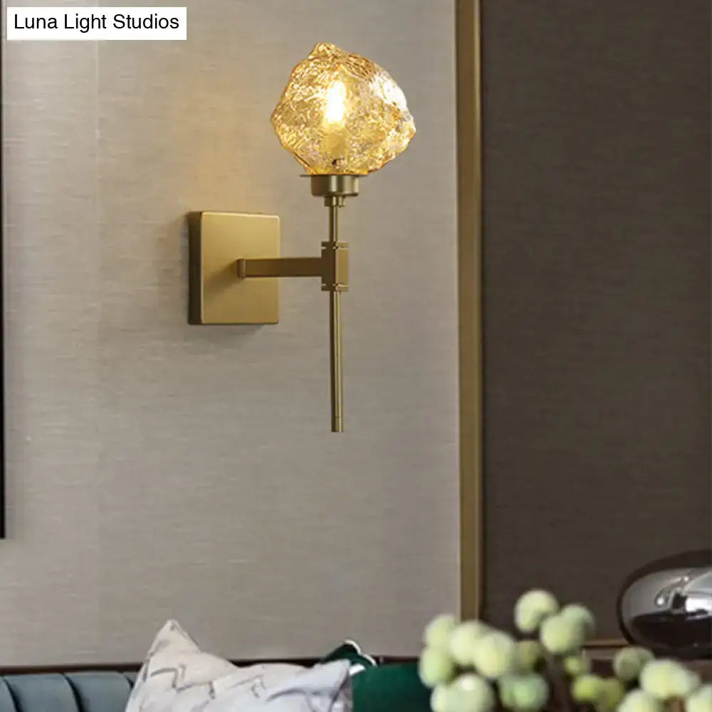 Modern gold amber smoke gray glass wall sconce with textured amber-colored globe for living room lighting