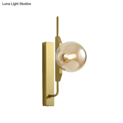 Modern gold and amber glass orb wall light fixture with sleek rectangular backplate for bedroom 110v-120v use