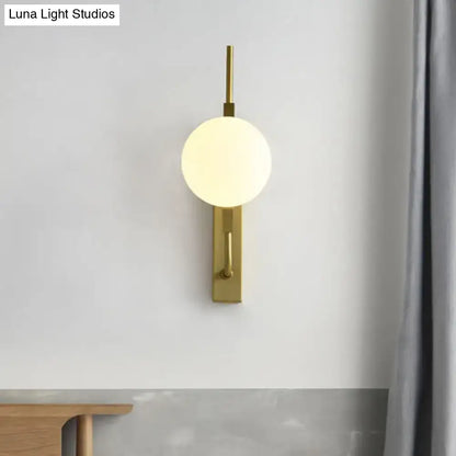 Modern gold and amber glass orb wall light fixture with frosted globe and metal accents for 110v-120v use