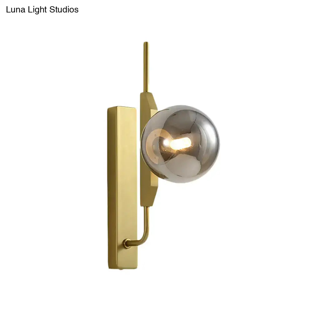 Modern gold and amber glass orb wall light fixture with brushed gold frame and smoke gray globe for 110v-120v use