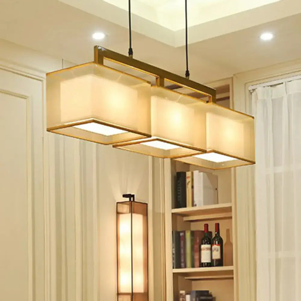 Modern gold and beige fabric island light with gold-toned metal frame for warm suspension lighting using led incandescent fluorescent