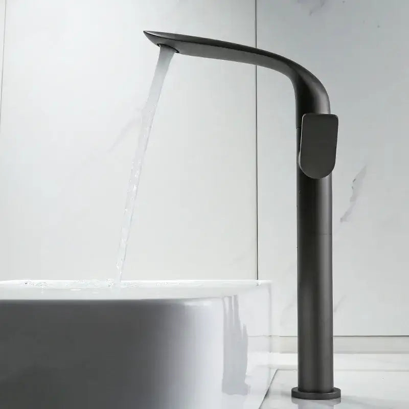 Modern gold and black decorbites basin faucet with a sleek curved matte black design and tall cylindrical body