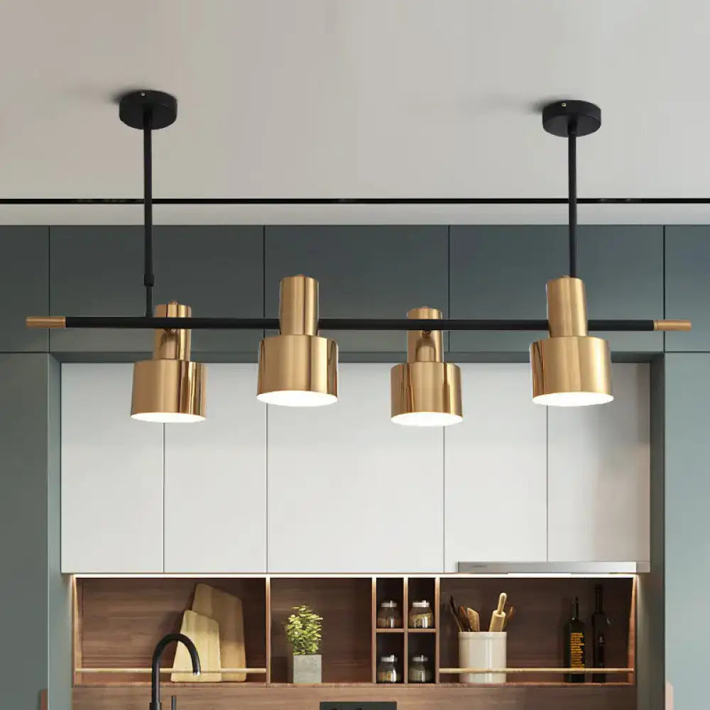 Modern gold and black drum pendant light with cylindrical shades and metal fixtures for dining room island lighting