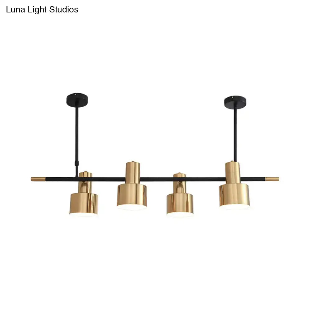 Modern gold and black drum pendant light with cylindrical shades and metal arms for dining room island lighting