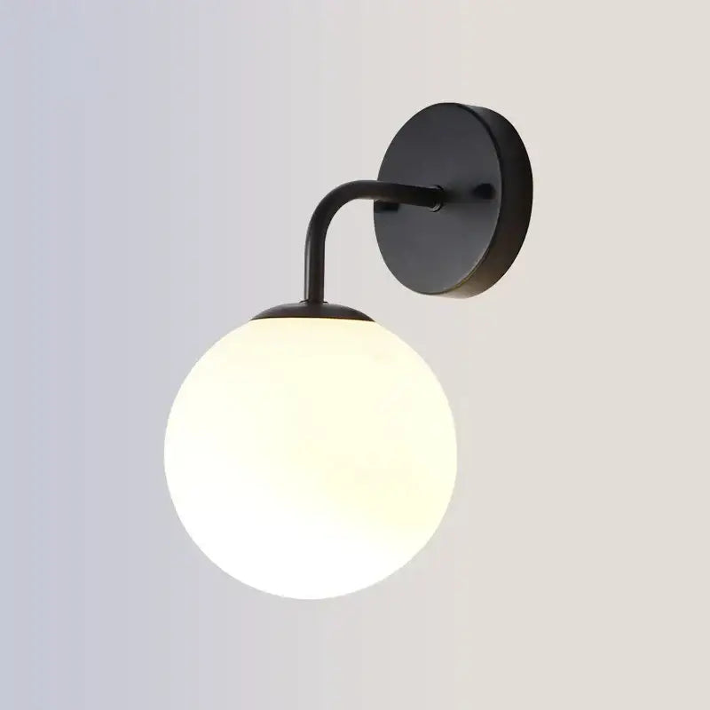Modern gold and black led glass ball wall lights featuring a black metal sconce with frosted glass globe for bedroom decorbites brozen black led