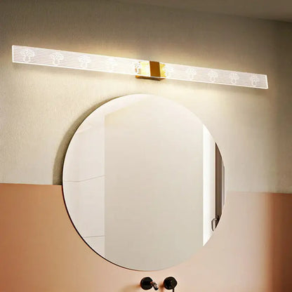 Modern gold and black led vanity sconce light with translucent white diffuser and etched tree patterns for bathroom wall use