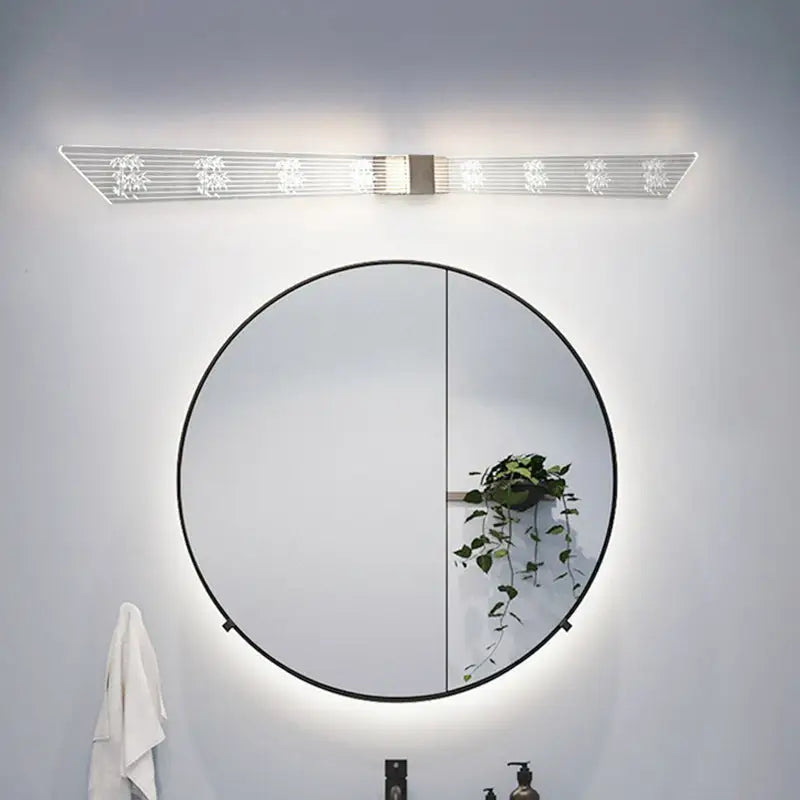 Modern gold and black led vanity sconce light with sleek frosted glass and floral etchings for bathroom walls