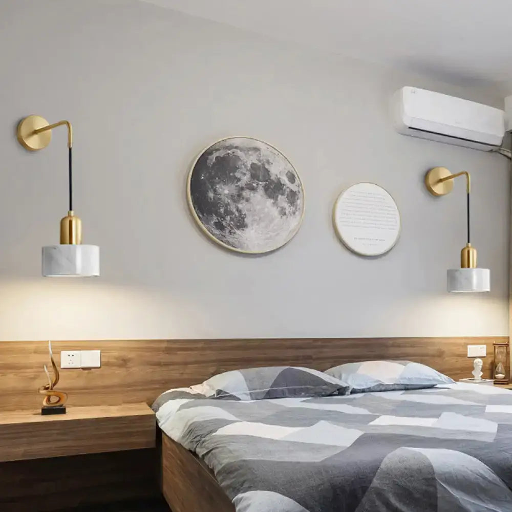 Modern gold wall sconces with white marble shades complement living room light fixture with maximum bulb wattage design