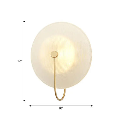 Modern gold and black wall lamp with frosted glass shade and metal frame designed for living rooms
