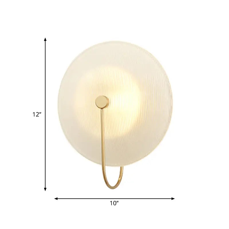 Modern gold and black wall lamp with frosted glass shade and metal frame designed for living rooms