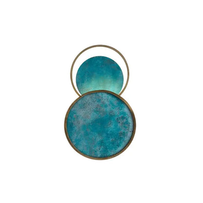 Blue textured circular wall art with brass-toned metallic frames.