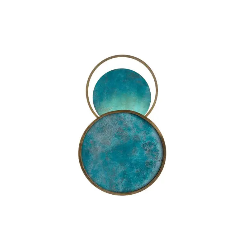 Blue textured circular wall art with brass-toned metallic frames.