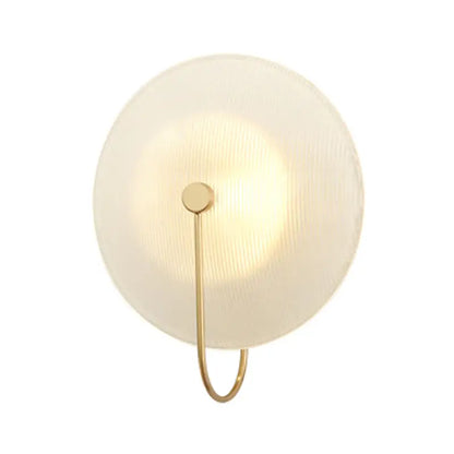 Modern gold and black orb wall lamp with frosted glass shade and slender brass frame for living room lighting