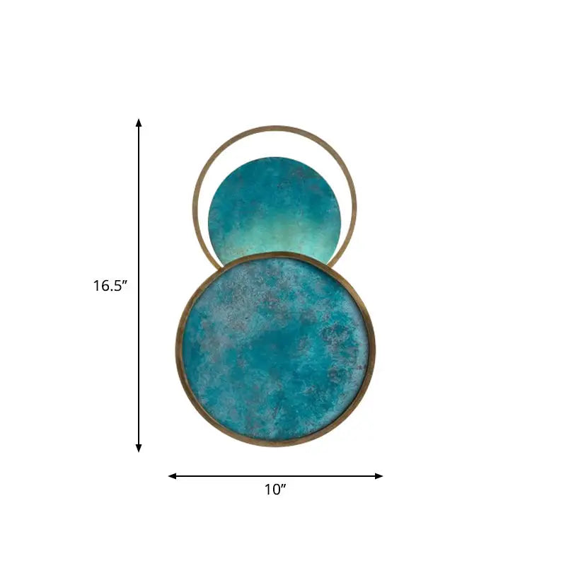 Two stacked circular coasters with a distressed turquoise patina and brass-colored rims, measuring 10 inches wide by 16.5 inches tall.