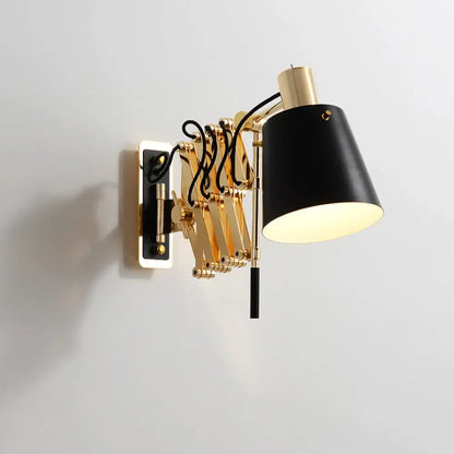 Modern gold and black wall sconce with black conical barrel shade and visible black wiring on articulated arm