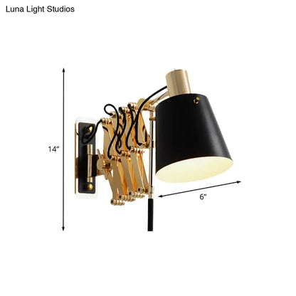 Modern gold and black wall sconce with a barrel shade and conical black shade on a gold articulated arm for bedroom lighting