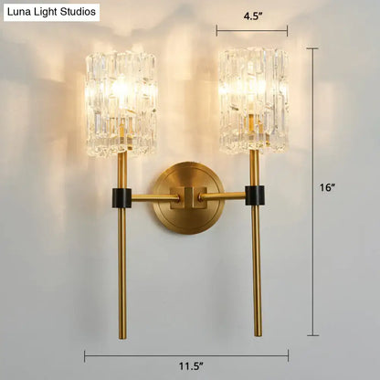 Modern gold and black wall sconce with gold finish, crystal cylindrical shades, and black accent bands as wall light