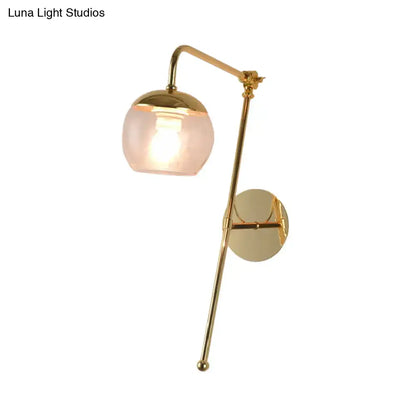 Modern gold and clear black glass ball sconce with gold-finished brass and frosted globe shade for bedroom wall light