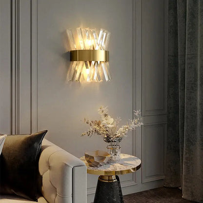 Modern gold and clear crystal led wall sconce with faceted crystal rods for elegant bedroom lighting decorbites crystal led